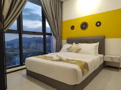 a bedroom with a large bed with a large window at Seaview Infinity Pool , 40th , 9pax, 3Rooms 2Carpark in Jelutong
