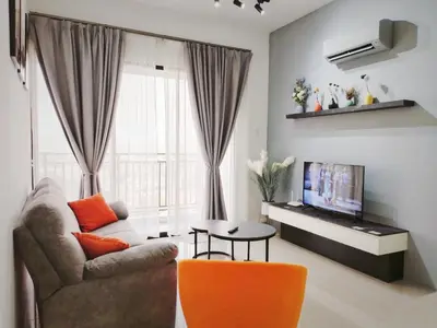 a living room with a couch and a tv at Ipoh Cove Hillview Suite 7-8 pax Tambun Lost World by City Home Empire in Ipoh