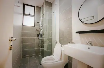 a bathroom with a toilet and a sink and a mirror at Ipoh Cove Hillview Suite 7-8 pax Tambun Lost World by City Home Empire in Ipoh