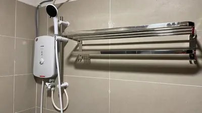 a hair dryer on a wall in a bathroom at RJ STUDIO 2- Kompleks Mutiara in Gua Musang