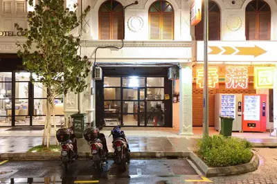 two motorcycles parked in front of a building at Dou Houz Georgetown in George Town