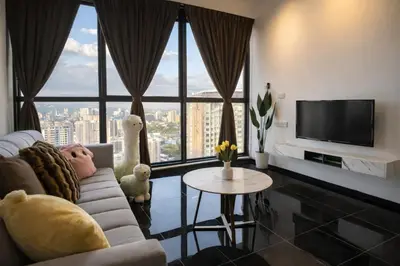 a living room with a couch and a large window at Urban Suites Georgetown l SeaView & CityView l Family Stay in Jelutong