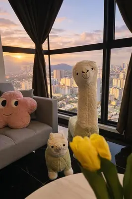 three stuffed animals sitting in a room with a window at Urban Suites Georgetown l SeaView & CityView l Family Stay in Jelutong