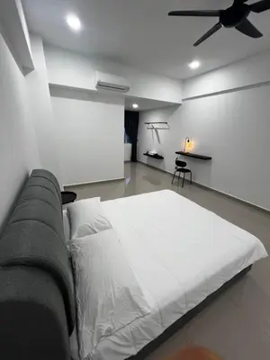 a bedroom with a white bed and a ceiling fan at Sense In Passionate in Sitiawan