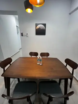 a wooden table with two glasses on top of it at Sense In Passionate in Sitiawan