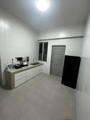 a white kitchen with a sink and a counter top at Sense In Passionate in Sitiawan