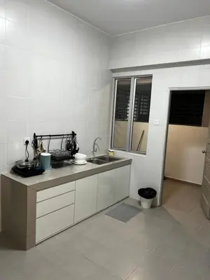 a kitchen with a sink and a counter top at Sense In Passionate in Sitiawan