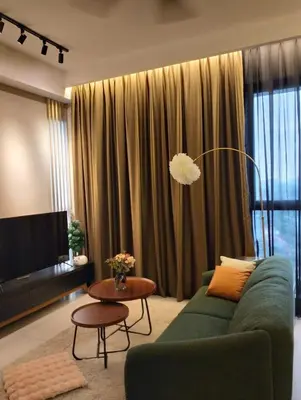 a living room with a green couch and a table at 