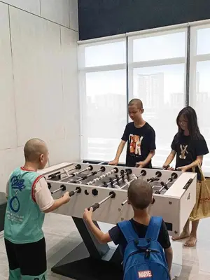 a group of young people playing with a large table at 