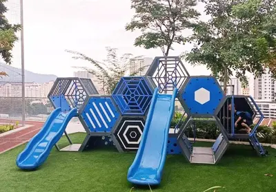 a playground with a blue slide on the grass at 
