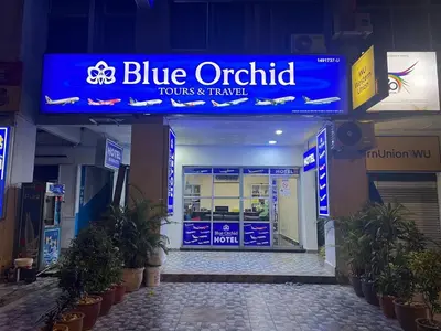 a blue outlook sign in front of a store at Hotel Blue Orchid in Bayan Lepas