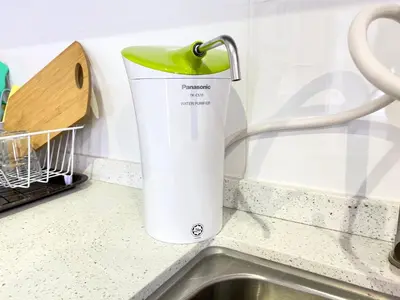 a white and green pitcher sitting next to a sink at Decozy 8.0 IpohTownCondo (10pax) in Ipoh