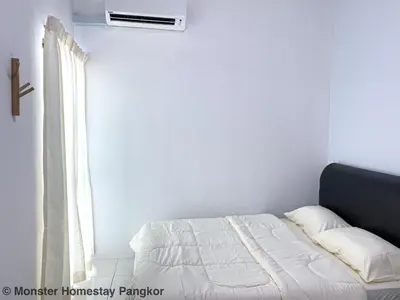 a white bedroom with a bed and a window at Sunshine Lot 10 Pangkor in Kampong Sungai Udang