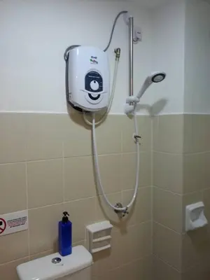 a shower in a bathroom with a toilet at Sunshine Lot 10 Pangkor in Kampong Sungai Udang