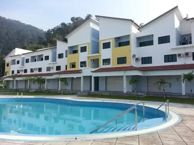 a building with a swimming pool in front of a building at Sunshine Lot 10 Pangkor in Kampong Sungai Udang