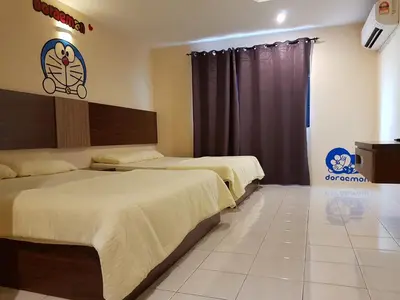a bedroom with two beds and a sign on the wall at Sunshine Lot 10 Pangkor in Kampong Sungai Udang