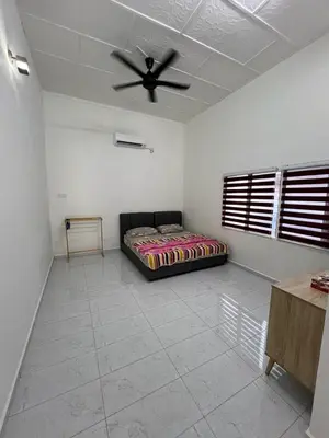 a bedroom with a bed and a ceiling fan at Agro Village Stay in Tapah