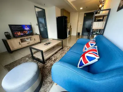 a blue couch and a coffee table in a living room at LS Tropicana 218*Sea View*1BR*Georgetown*King Bed in George Town