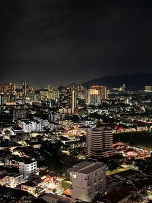 a city lit up at night with buildings at LS Tropicana 218*Sea View*1BR*Georgetown*King Bed in George Town