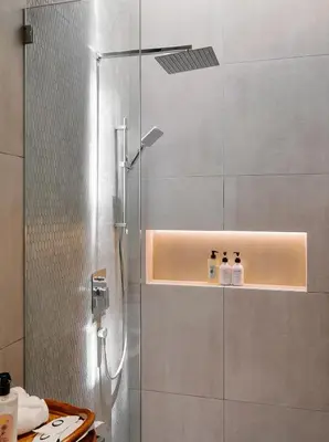 a bathroom with a shower with three bottles on a shelf at Mint Villa with Jacuzzi Pool in George Town