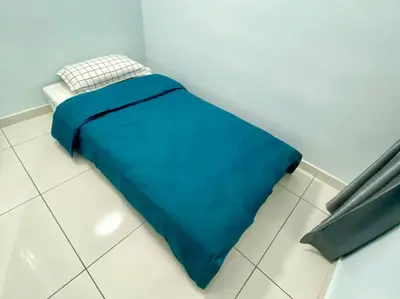 a blue bed sitting on the floor in a room at Decozy7.0 Ipoh Town Condo(12pax) in Ipoh