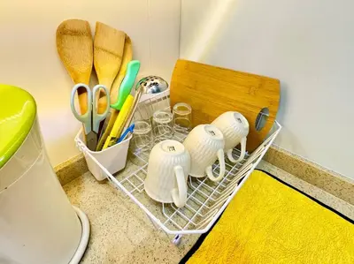 a drying rack with scissors and other utensils on a counter at Decozy7.0 Ipoh Town Condo(12pax) in Ipoh