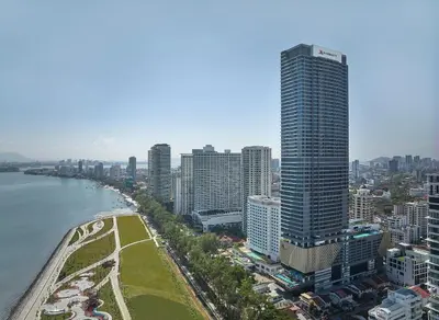 an aerial view of a city with a tall building at Marriott Executive Apartments Penang in George Town