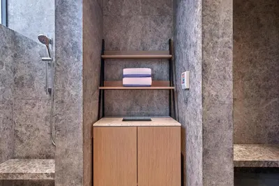 a bathroom with a shower with a towel on a shelf at Marriott Executive Apartments Penang in George Town