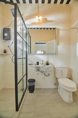 a bathroom with a toilet and a sink and a mirror at Rose Cottage by De'La Ferns in Tanah Rata
