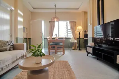 a living room with a couch and a table at Rose Cottage by De'La Ferns in Tanah Rata
