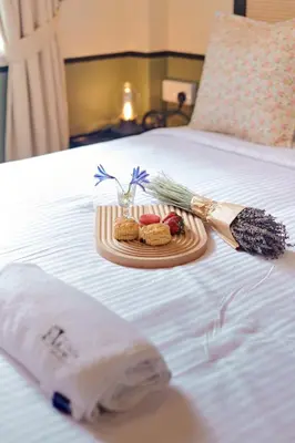 a tray of food on top of a bed at Rose Cottage by De'La Ferns in Tanah Rata