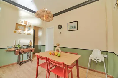 a kitchen and dining room with a table and chairs at Rose Cottage by De'La Ferns in Tanah Rata