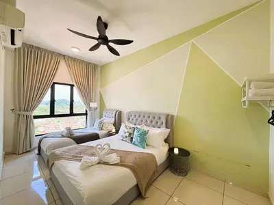 a bedroom with two beds and a ceiling fan at The Horizon Ipoh Emerald by Grab A Stay in Ipoh