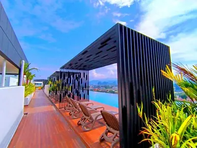a deck with chairs and a view of the water at The Horizon Ipoh Emerald by Grab A Stay in Ipoh