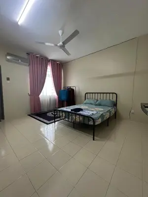 a bedroom with a bed and a ceiling fan at Teratak Amaris Homestay MELAYU ONLY in Sungai Petani
