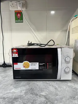 a microwave oven sitting on top of a counter at Teratak Amaris Homestay MELAYU ONLY in Sungai Petani
