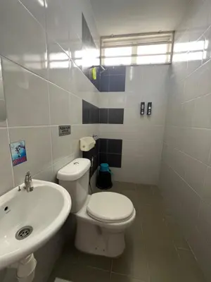 a bathroom with a white toilet and a sink at Teratak Amaris Homestay MELAYU ONLY in Sungai Petani