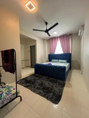 a living room with a blue couch and a window at Teratak Amaris Homestay MELAYU ONLY in Sungai Petani