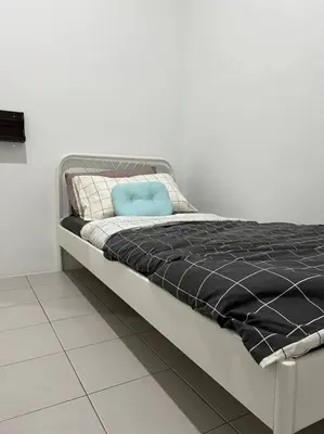 a bed with a blue pillow on top of it at Pusing Kampung Affordable Homestay Astro in Pusing