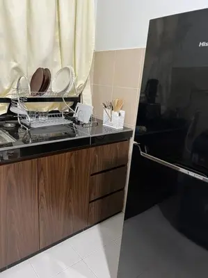 a kitchen with a counter with plates and utensils at Pusing Kampung Affordable Homestay Astro in Pusing