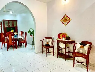 a dining room with a table and chairs at Cozy Modern Classic Home in Ipoh in Ipoh