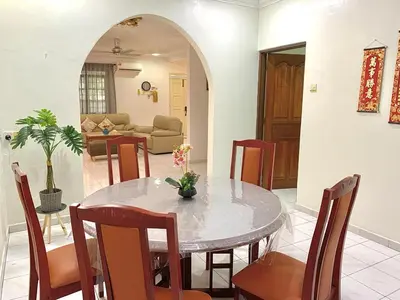 a dining room with a table and chairs at Cozy Modern Classic Home in Ipoh in Ipoh