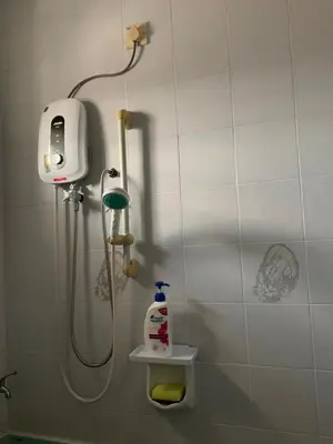 a bathroom with a shower with a soap dispenser at Cozy Modern Classic Home in Ipoh in Ipoh