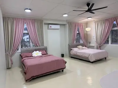 a bedroom with two beds and a ceiling fan at The Hidden 7 in Taiping