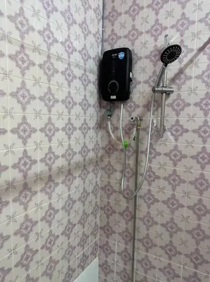 a shower in a bathroom with a blow dryer on the wall at The Hidden 7 in Taiping