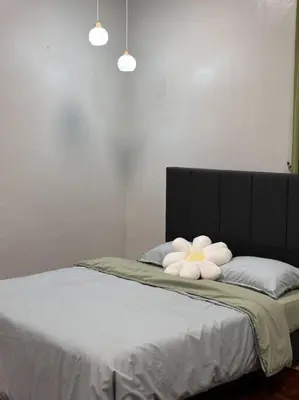 a bed with two white towels on top of it at The Hidden 7 in Taiping