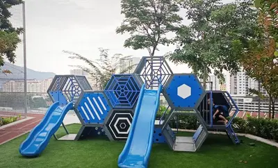 a playground with a blue slide on the grass at Urban Suites 3 Rooms, Cat Theme & Romantic in Jelutong