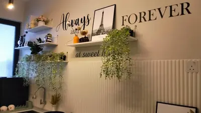 a room with shelves with plants on the wall at Romantic Sea View Room @ Urban Suites, Jelutong in Jelutong