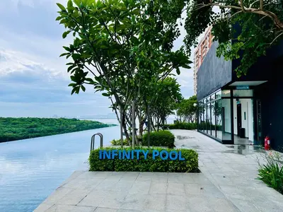 a sign in front of a building next to a body of water at 2BR OR 3BR Wonderful Homestay at Urban Suite BY LJ PULSE in Jelutong