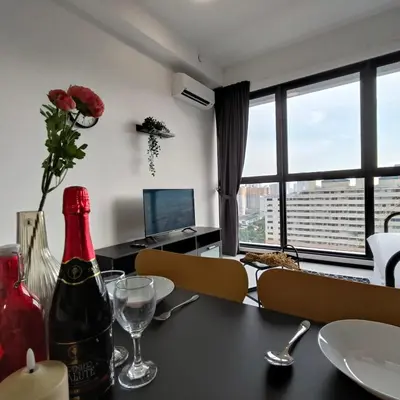 a dining room with a table with a bottle of wine at 2BR OR 3BR Wonderful Homestay at Urban Suite BY LJ PULSE in Jelutong